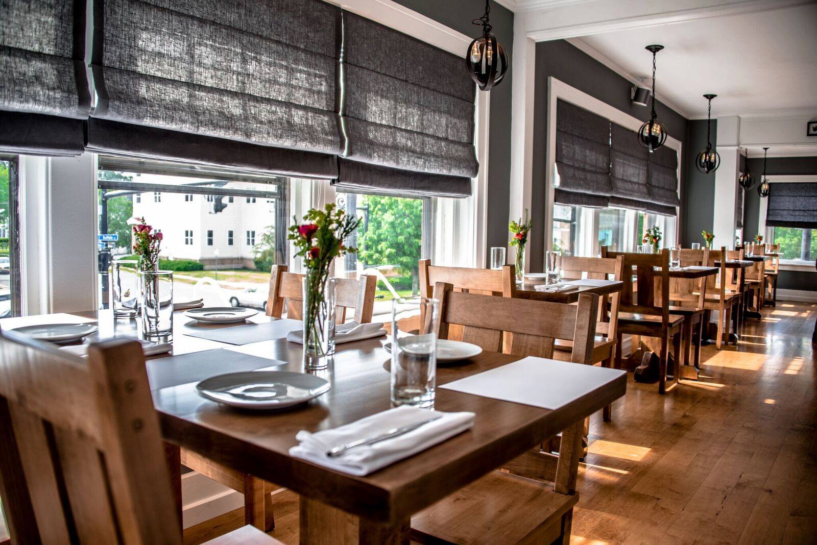 https://www.carteblanchehamburg.com/wp-content/uploads/2021/04/Carte-Blanche-Restaurant-Hamburg-NY-Upsairs-Dining-Room-with-wood-tables-and-hardwood-floors.jpg