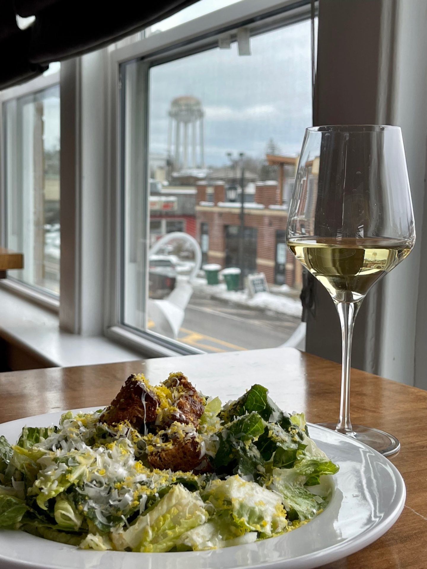 salad and wine on a table at carte blanche overlooking hamburg ny